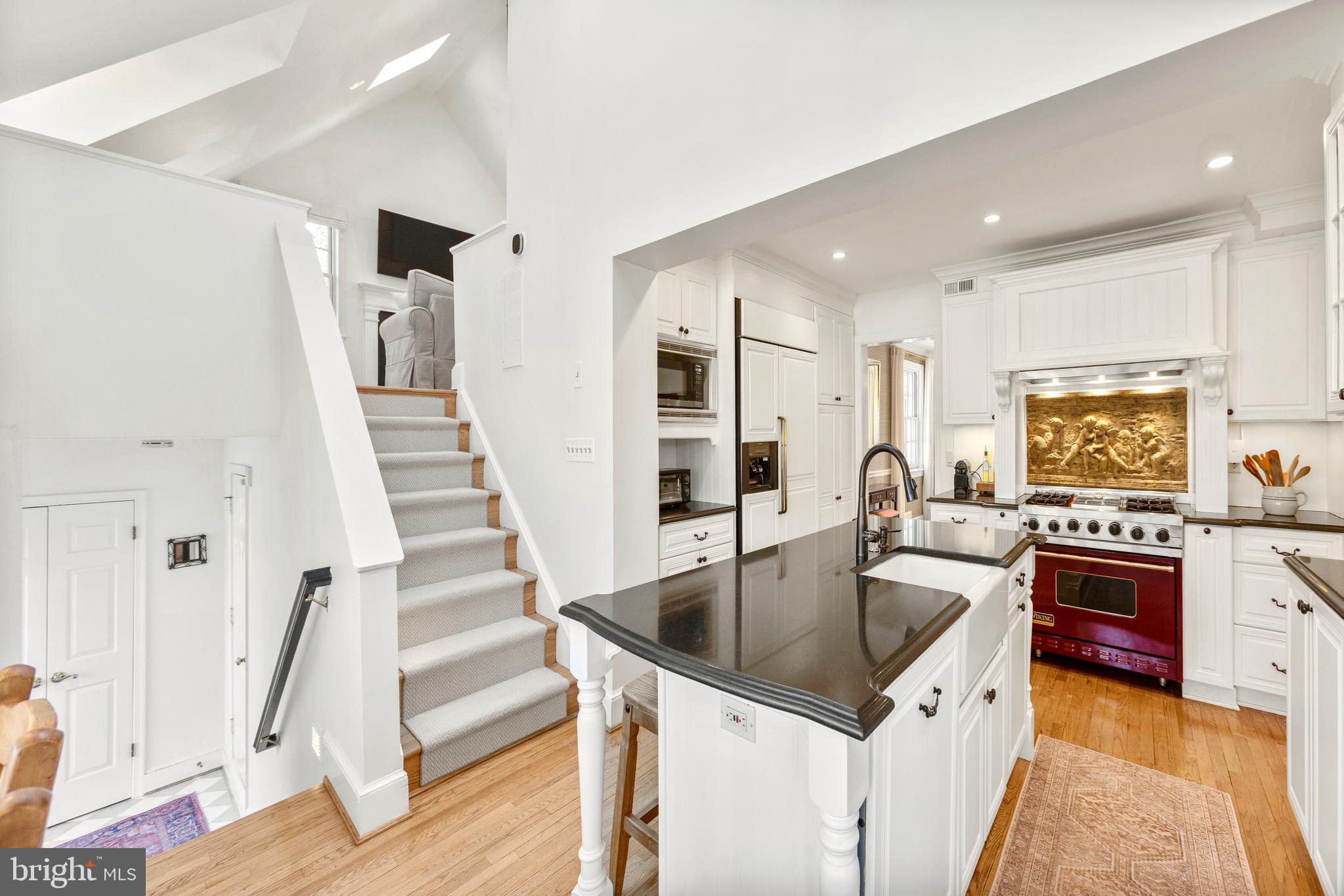 3303 Rolling Road Chevy Chase, MD 20815 - Photo 14 of 51 a kitchen with granite countertop a sink a counter top space cabinets and stainless steel appliances