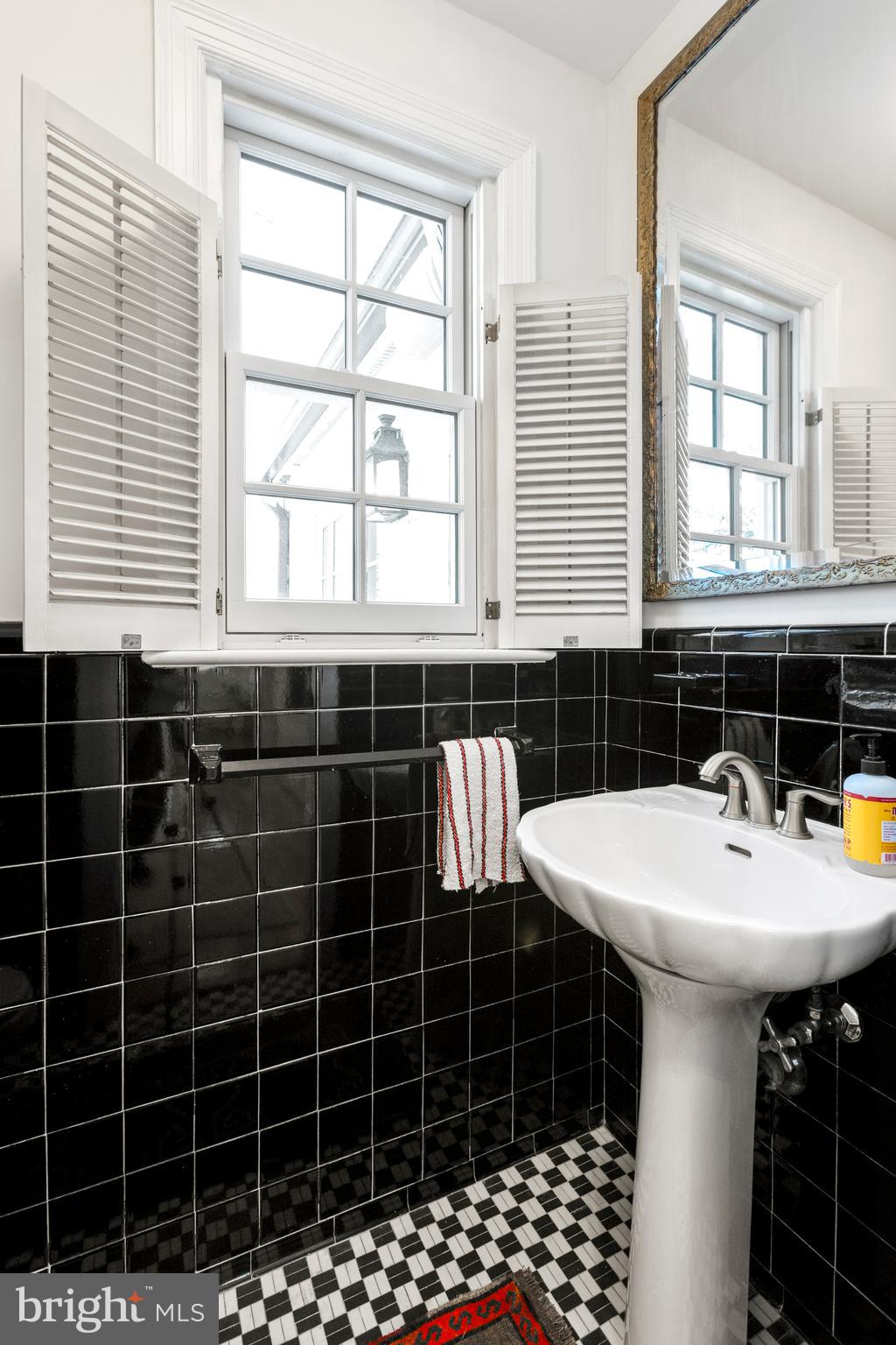 3303 Rolling Road Chevy Chase, MD 20815 - Photo 17 of 51 a bathroom with a sink a shower and a mirror