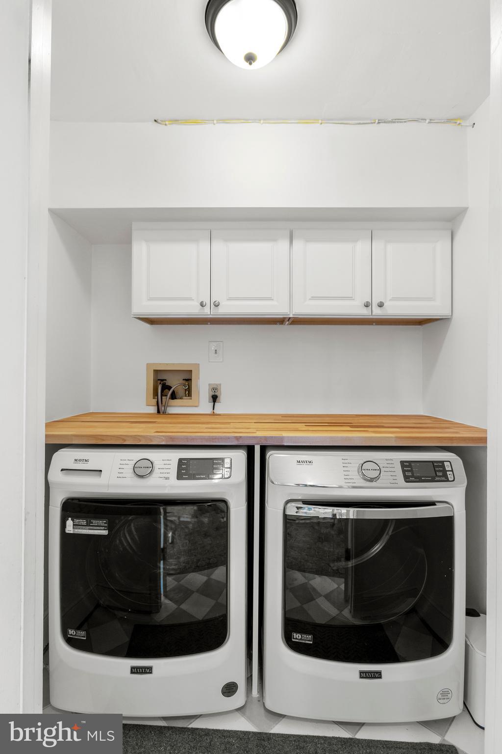 3303 Rolling Road Chevy Chase, MD 20815 - Photo 18 of 51 a stove top oven sitting inside of a kitchen with stainless steel appliances wooden floor
