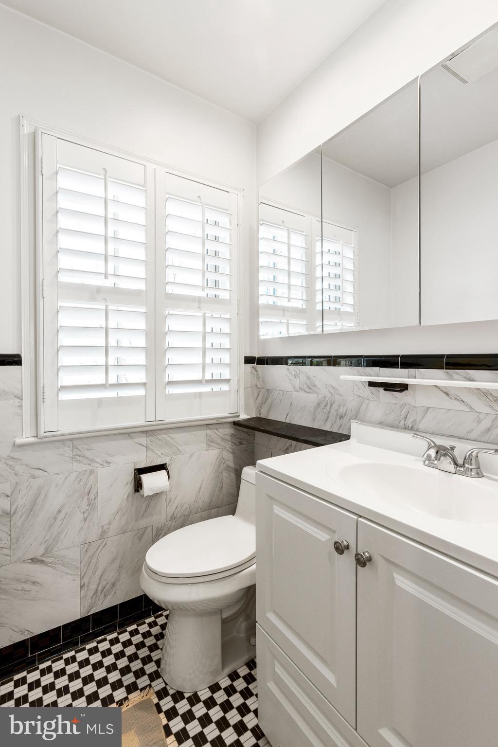 3303 Rolling Road Chevy Chase, MD 20815 - Photo 21 of 51 a bathroom with a sink a toilet and a window