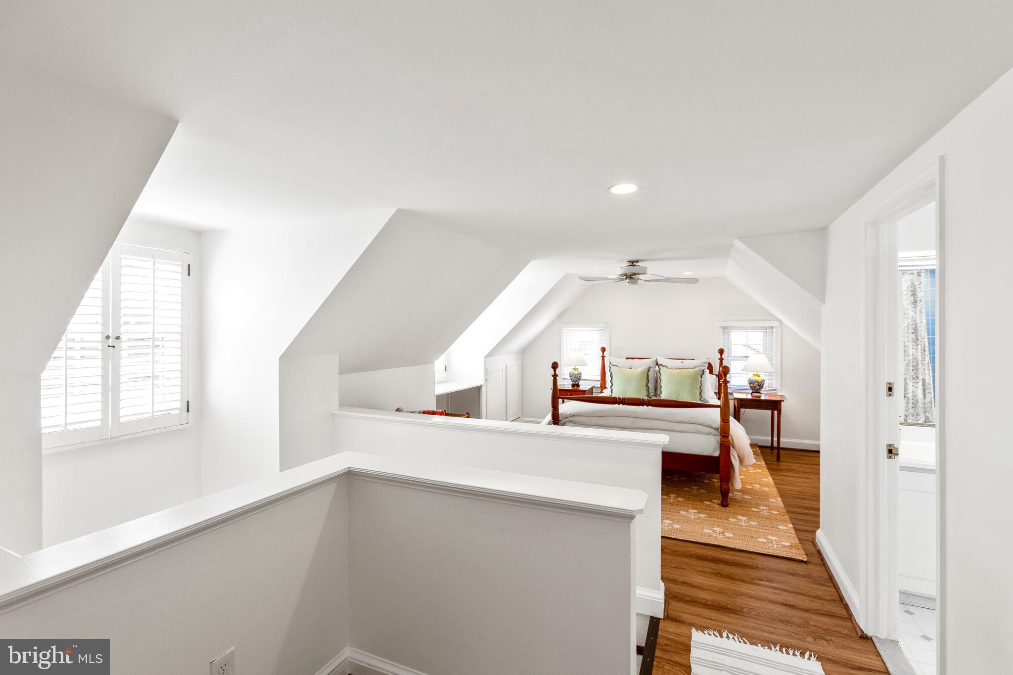 3303 Rolling Road Chevy Chase, MD 20815 - Photo 26 of 51 a view of a hallway with wooden floor and staircase
