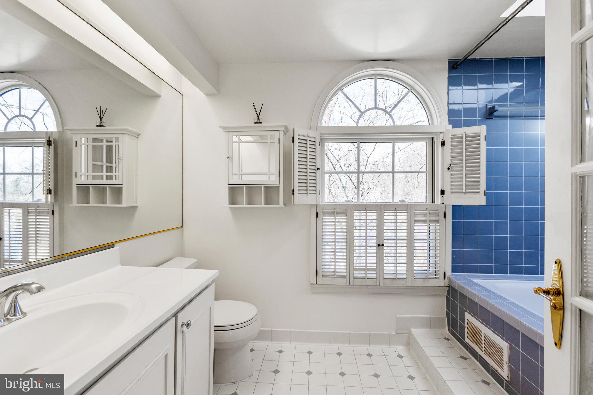 3303 Rolling Road Chevy Chase, MD 20815 - Photo 30 of 51 a bathroom with a sink a toilet and a window