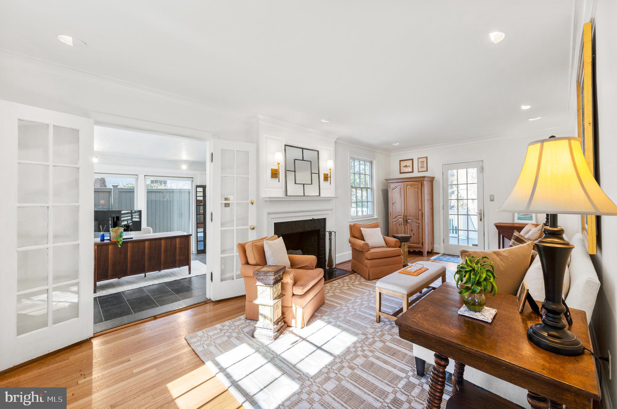 3303 Rolling Road Chevy Chase, MD 20815 - Photo 3 of 51 a living room with furniture a fireplace and a table