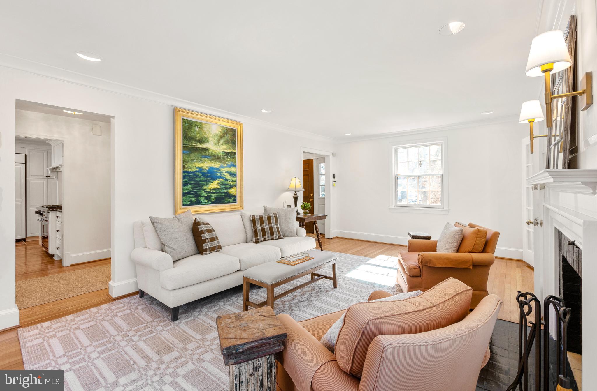 3303 Rolling Road Chevy Chase, MD 20815 - Photo 4 of 51 a living room with furniture a fireplace and a large window