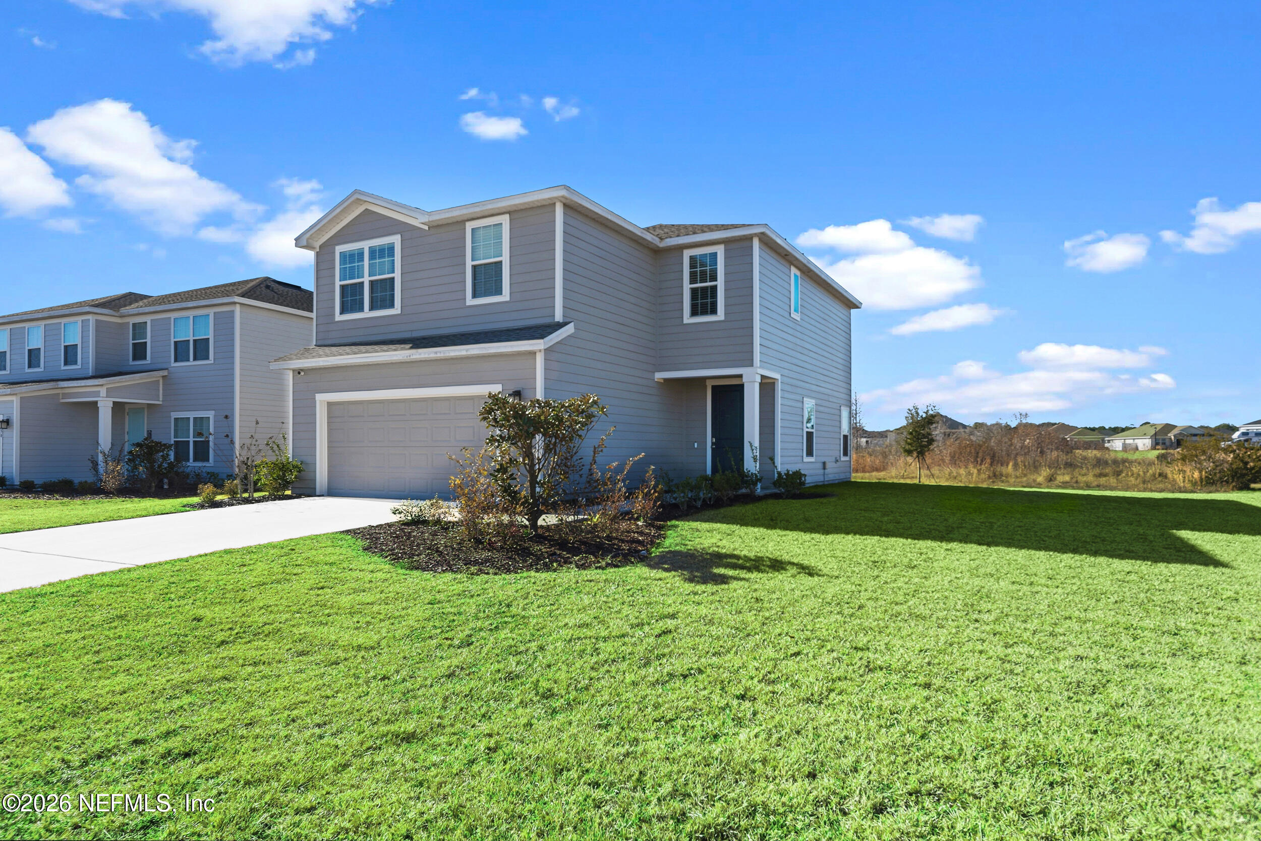 1052 Victoria Hills Jacksonville, FL 32221 - Photo 1 of 27 a front view of a house with a garden and yard