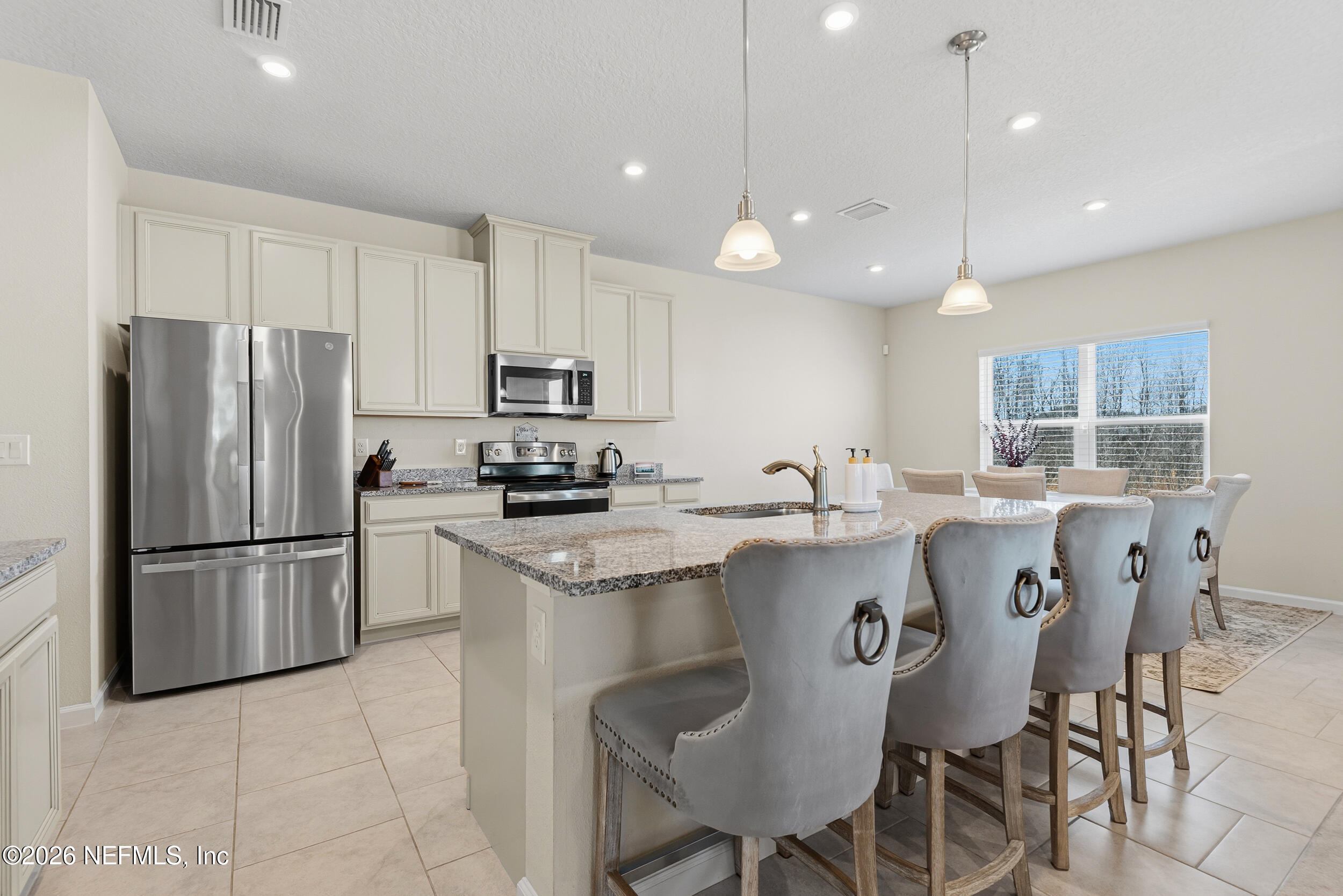 1052 Victoria Hills Jacksonville, FL 32221 - Photo 5 of 27 a kitchen with kitchen island granite countertop a sink a center island and stainless steel appliances