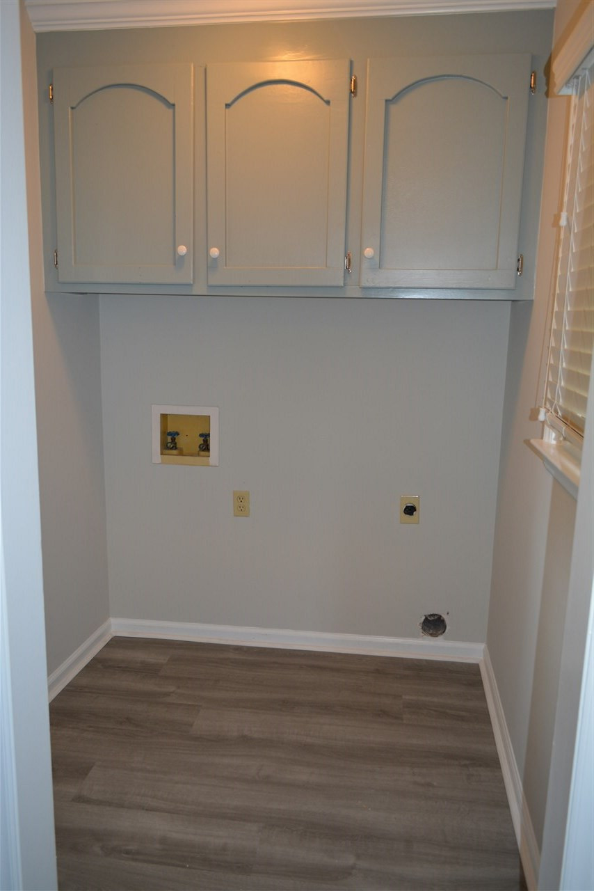 5236 Carrier Way Raleigh, NC 27603 - Photo 19 of 22 New wall paint, new trim paint, new luxury vinyl floor Nice utility room with newly painted cabinets