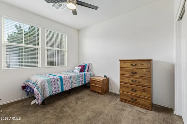a bedroom with a bed and a dresser
