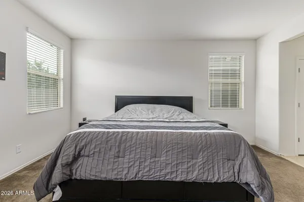 a bedroom with a bed and window