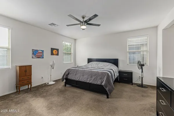 a bedroom with a bed and cabinet