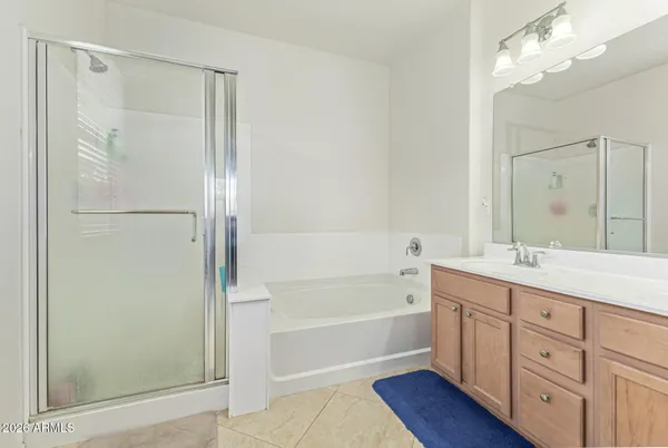 a bathroom with a tub a sink and mirrors