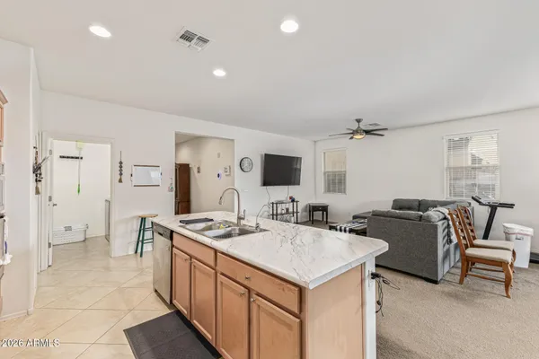 a large white kitchen with a table and chairs
