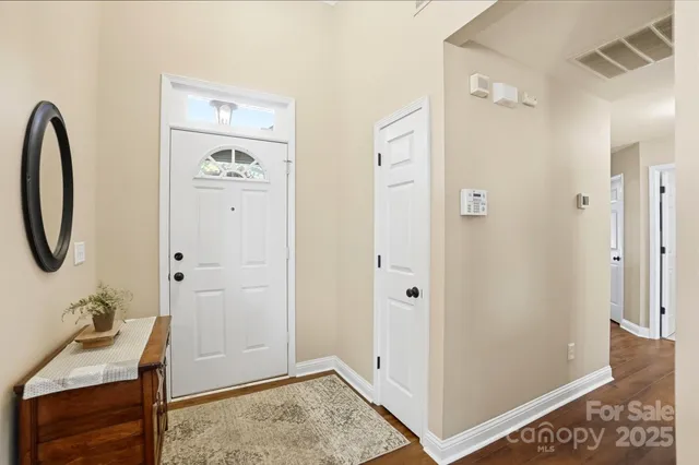 a bathroom with a granite countertop sink a mirror and a shower