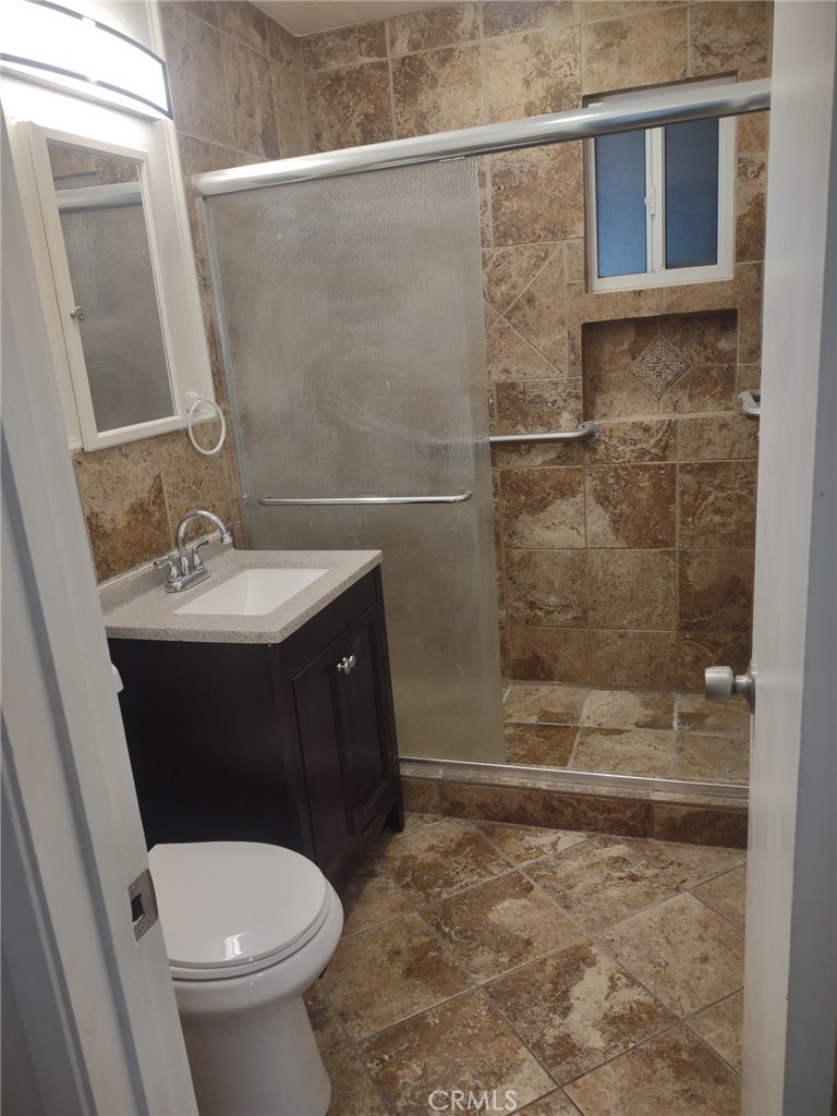 1121 Mojave Drive Barstow, CA 92311 - Photo 3 of 9 a bathroom with a sink a toilet and shower