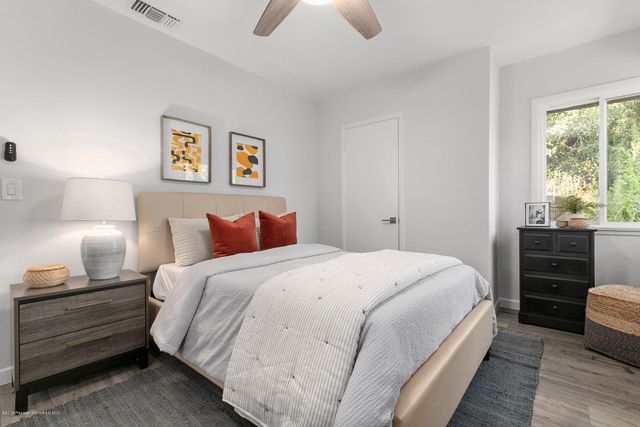 a bed room with a bed and a night stand