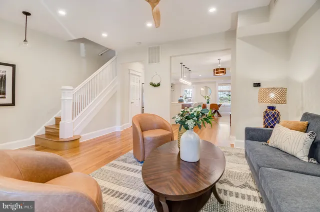 a living room with furniture and a potted plant