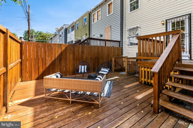 a view of a roof deck with wooden floor and outdoor seating