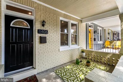 a view of a building and car parked on the roadside