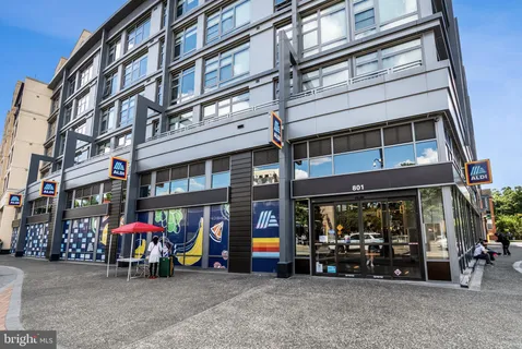 a view of a building with a street light and sign board