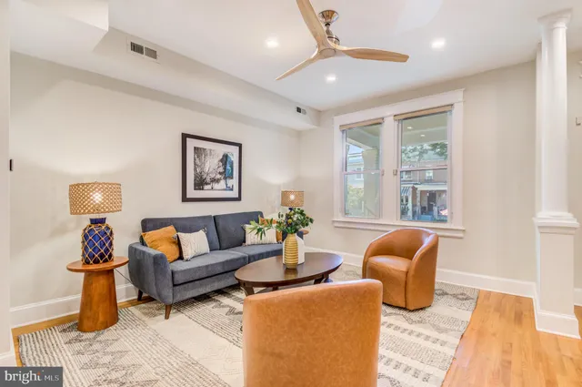 a very nice looking dining room with a large window and stainless steel appliances