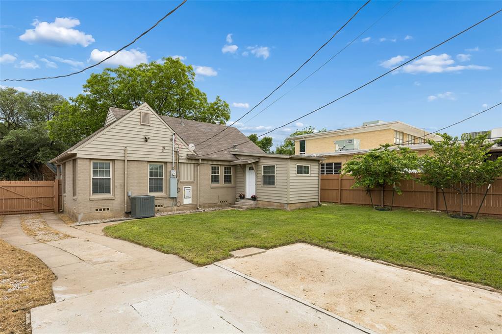 2427 Alco Avenue Dallas, TX 75211 - Photo 21 of 26 a front view of a house with a garden and yard