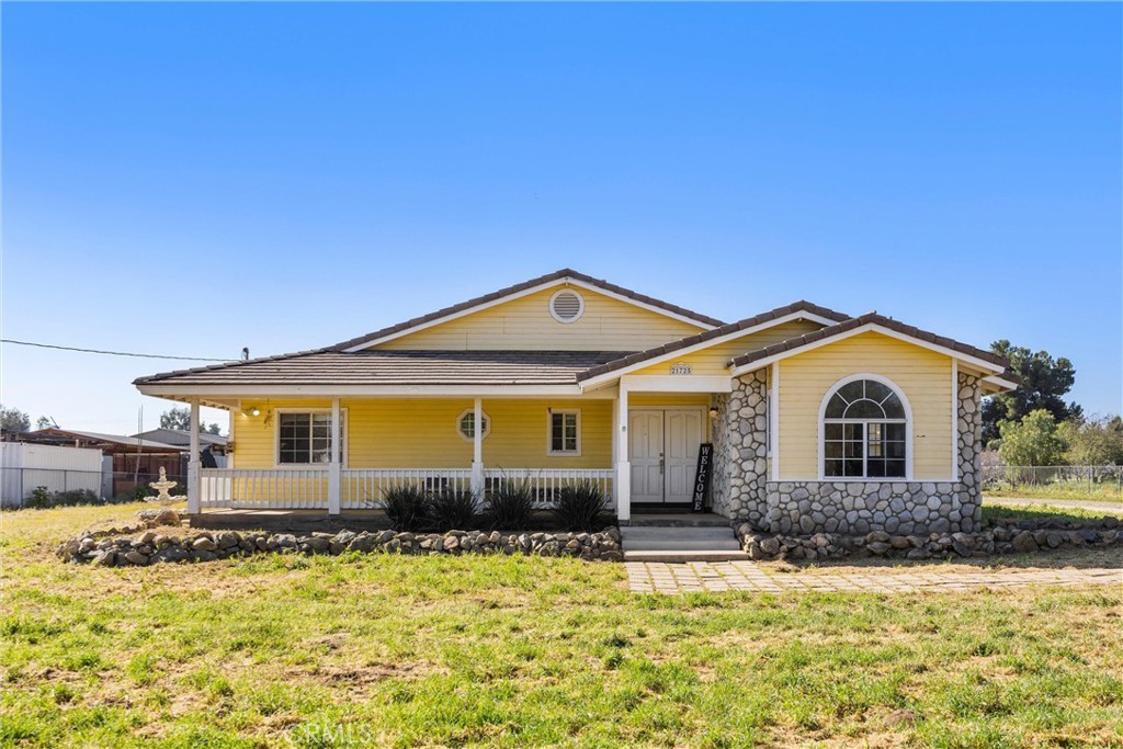 21725 Pinewood Street Perris, CA 92570 - Photo 1 of 1 a front view of a house with a yard