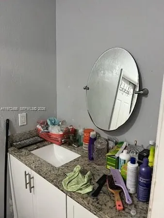 a bedroom with a bed and a mirror