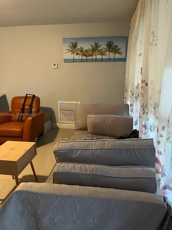 a living room with furniture and painting on the wall