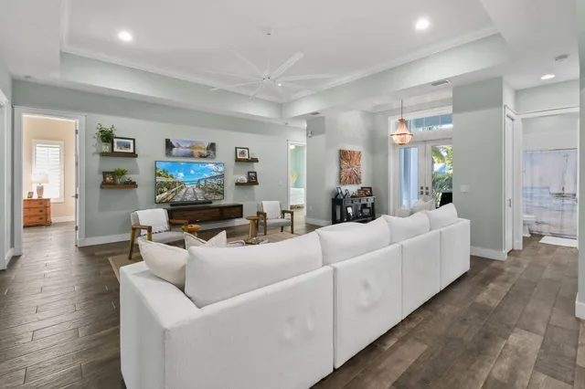 a kitchen with kitchen island granite countertop a table chairs sink and cabinets