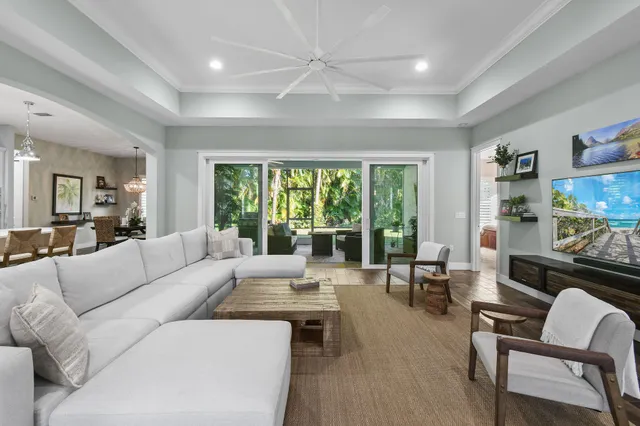 a kitchen with stainless steel appliances a sink dishwasher and white cabinets next to a window