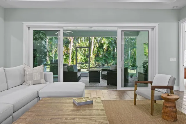 a kitchen with granite countertop a refrigerator stove and white cabinets