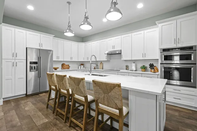 a view of a dining room with furniture wooden floor and a chandelier