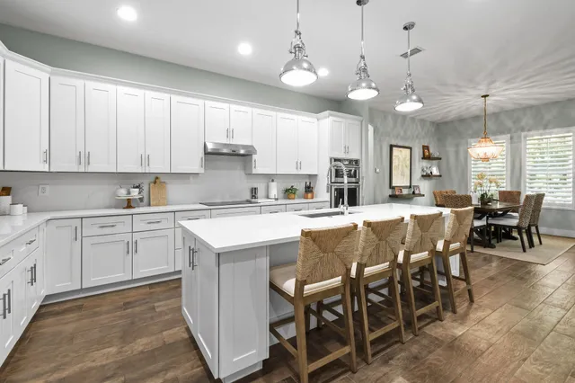 a view of a dining room with furniture wooden floor and chandelier