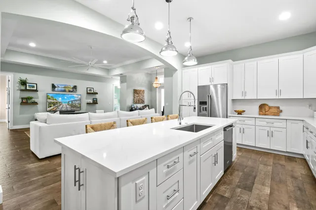 a large bedroom with a bed and a chandelier