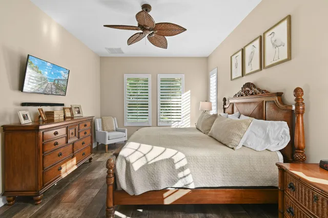a bedroom with a large bed and a chandelier