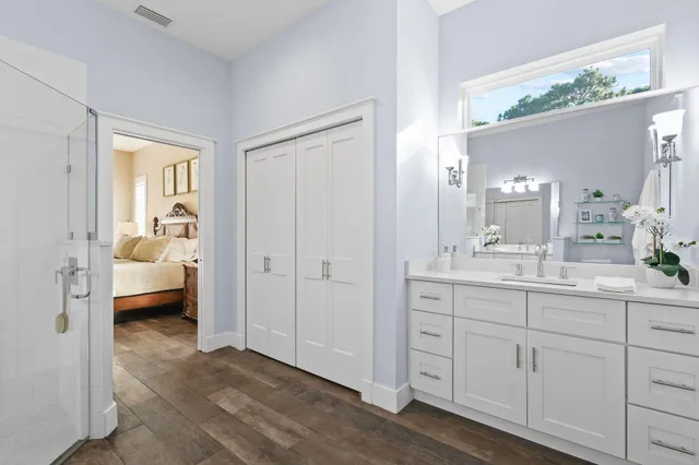 a bathroom with a sink a toilet and shower