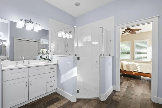 a bathroom with a sink a toilet and shower