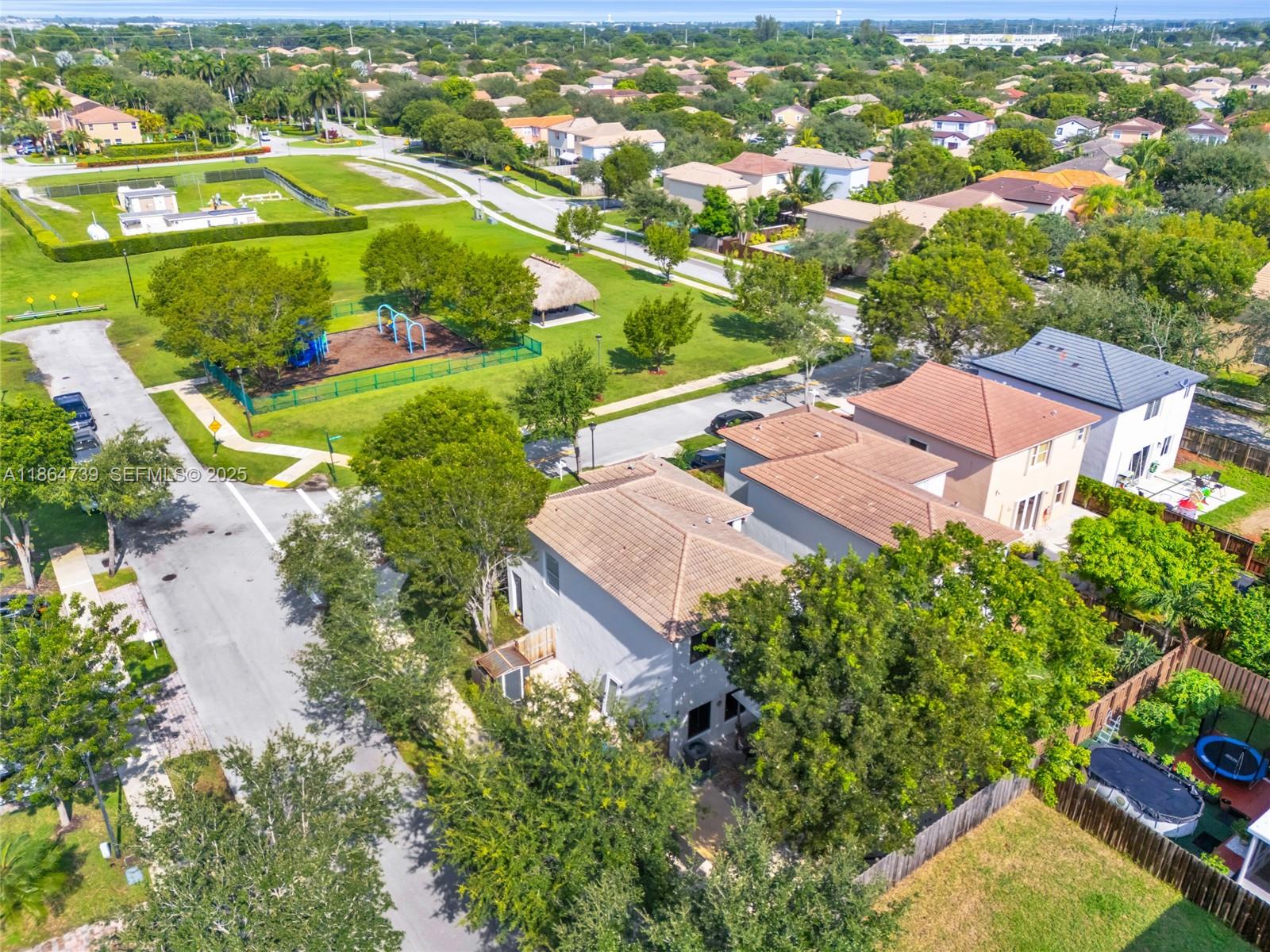 1635 Southeast 20th Terrace Homestead, FL 33035 - Photo 15 of 52 an aerial view of residential houses with outdoor space and trees