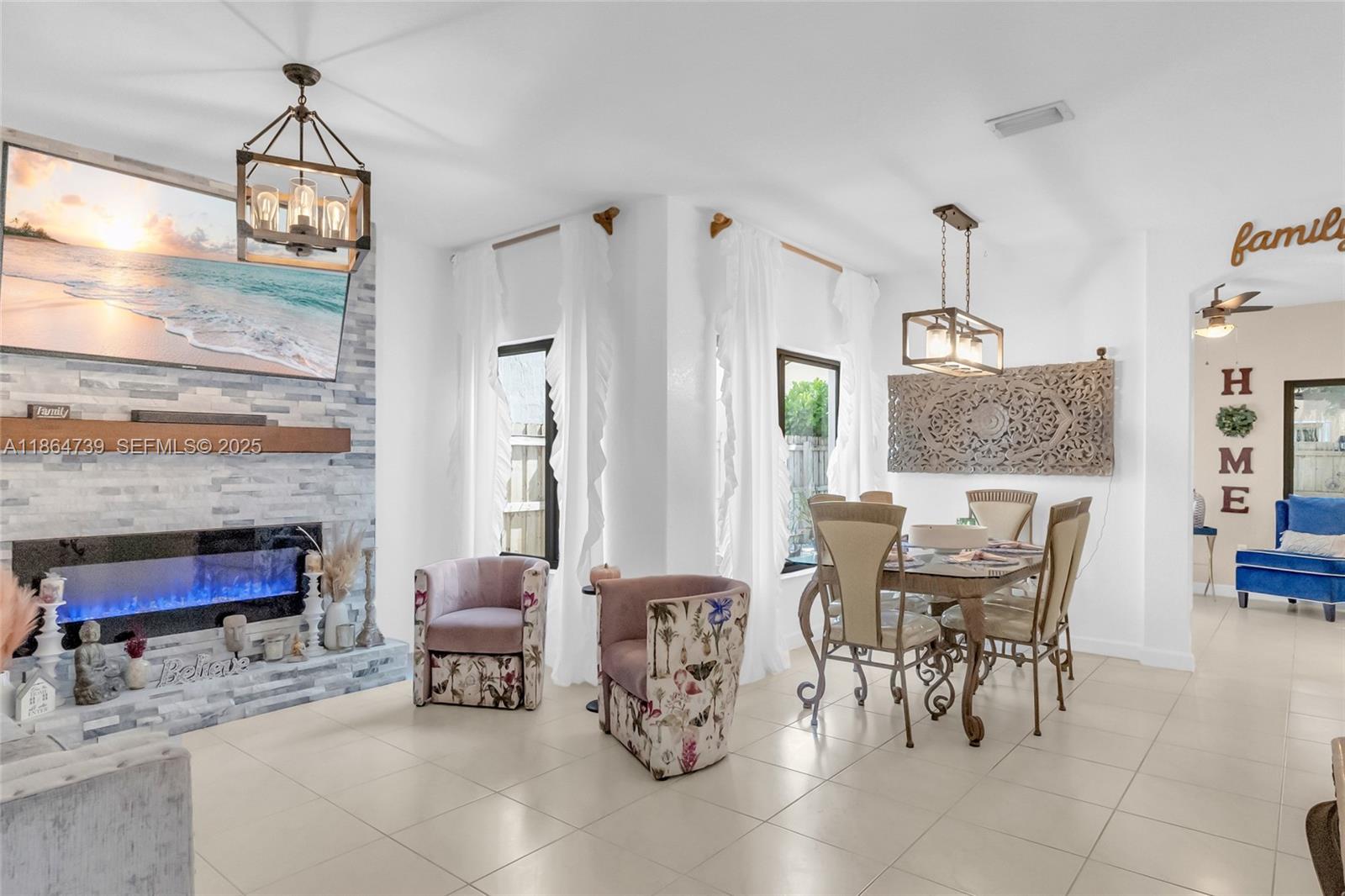 1635 Southeast 20th Terrace Homestead, FL 33035 - Photo 20 of 52 a dining room with furniture a chandelier and wooden floor