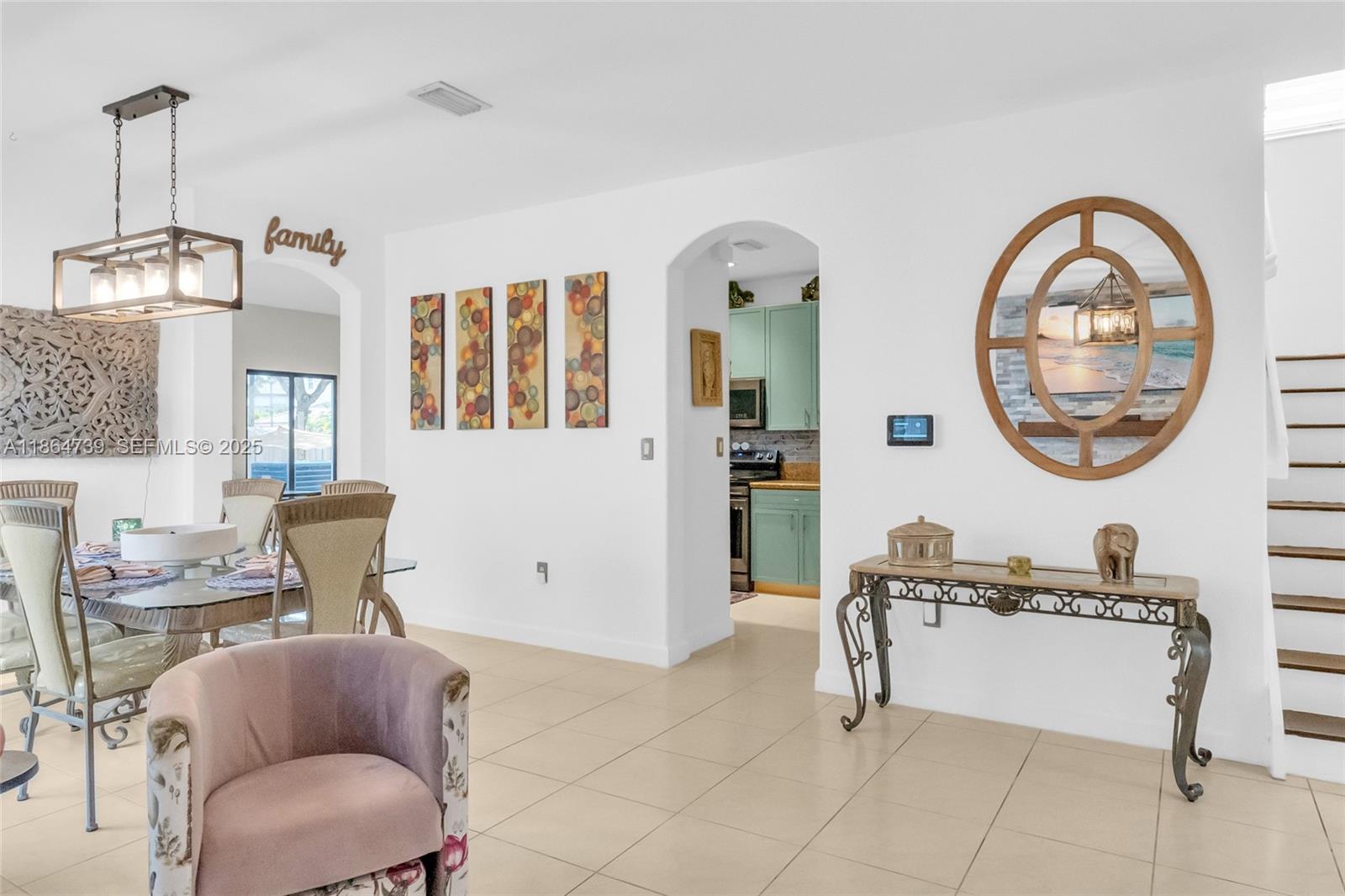 1635 Southeast 20th Terrace Homestead, FL 33035 - Photo 22 of 52 a living room with furniture a mirror and a table