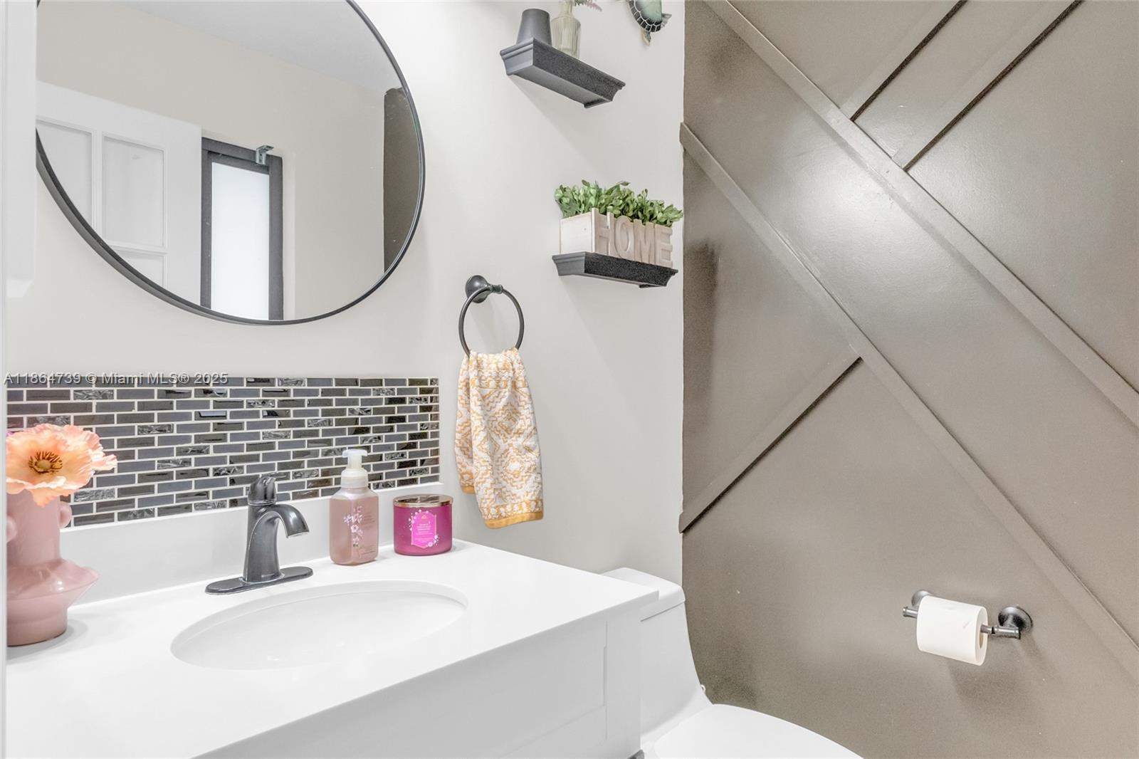 1635 Southeast 20th Terrace Homestead, FL 33035 - Photo 25 of 52 a bathroom with a sink a toilet and a mirror