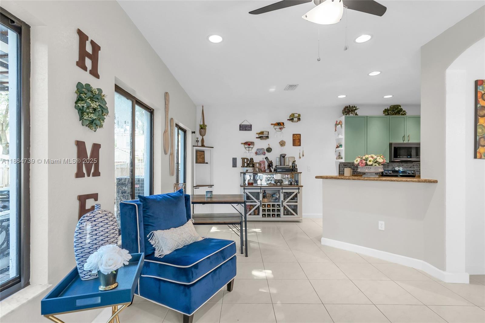 1635 Southeast 20th Terrace Homestead, FL 33035 - Photo 26 of 52 a living room with furniture a rug and white walls