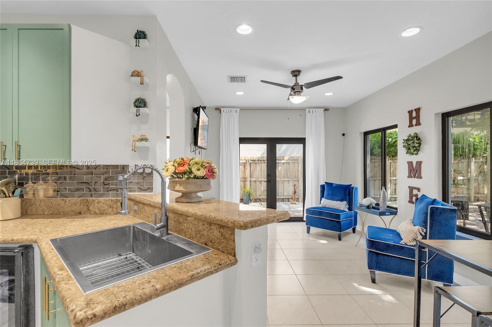 1635 Southeast 20th Terrace Homestead, FL 33035 - Photo 29 of 52 a kitchen with a stove a faucet a dining table and chairs