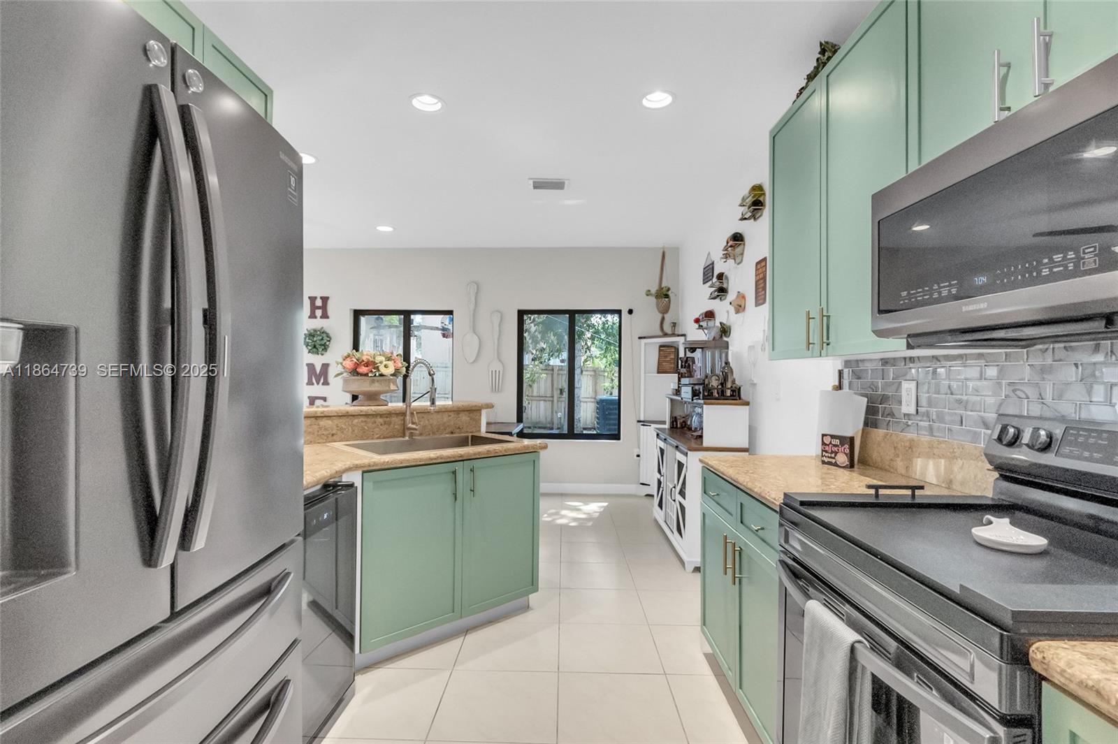 1635 Southeast 20th Terrace Homestead, FL 33035 - Photo 31 of 52 a kitchen with stainless steel appliances granite countertop a refrigerator a sink and a stove