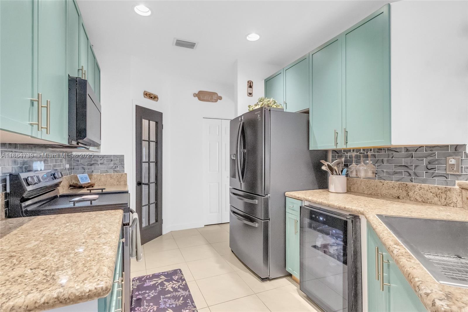 1635 Southeast 20th Terrace Homestead, FL 33035 - Photo 32 of 52 a kitchen with a refrigerator sink and stove