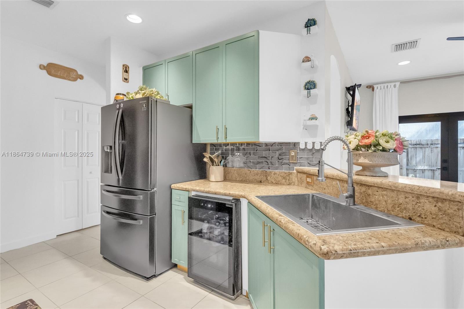 1635 Southeast 20th Terrace Homestead, FL 33035 - Photo 33 of 52 a kitchen with stainless steel appliances granite countertop a sink stove and refrigerator