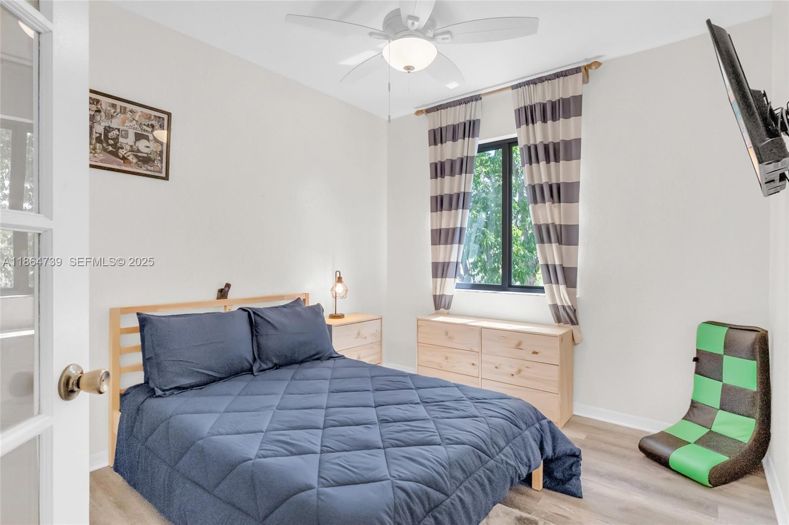 1635 Southeast 20th Terrace Homestead, FL 33035 - Photo 39 of 52 a bedroom with a bed and a window