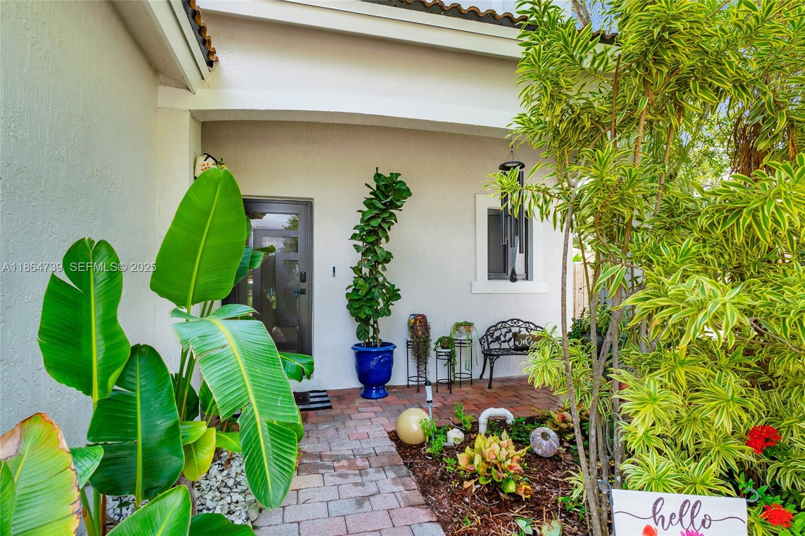 1635 Southeast 20th Terrace Homestead, FL 33035 - Photo 4 of 52 a vase of flowers sitting in front of a door