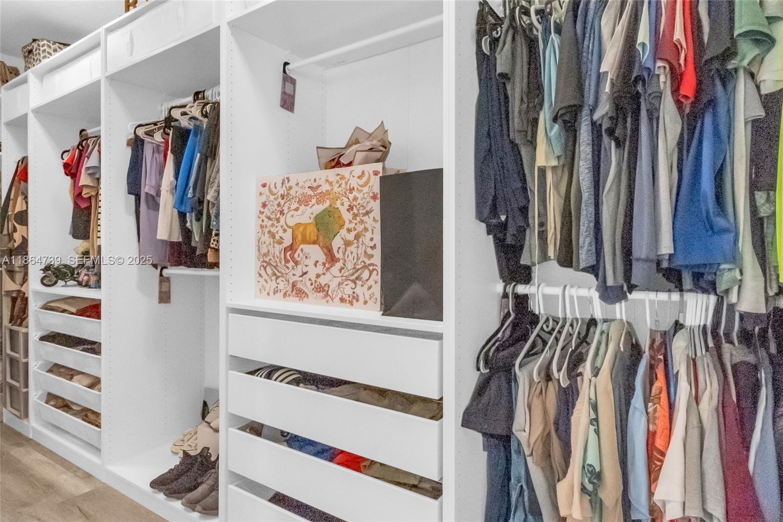 1635 Southeast 20th Terrace Homestead, FL 33035 - Photo 45 of 52 a view of walk in closet with clothes and shoes