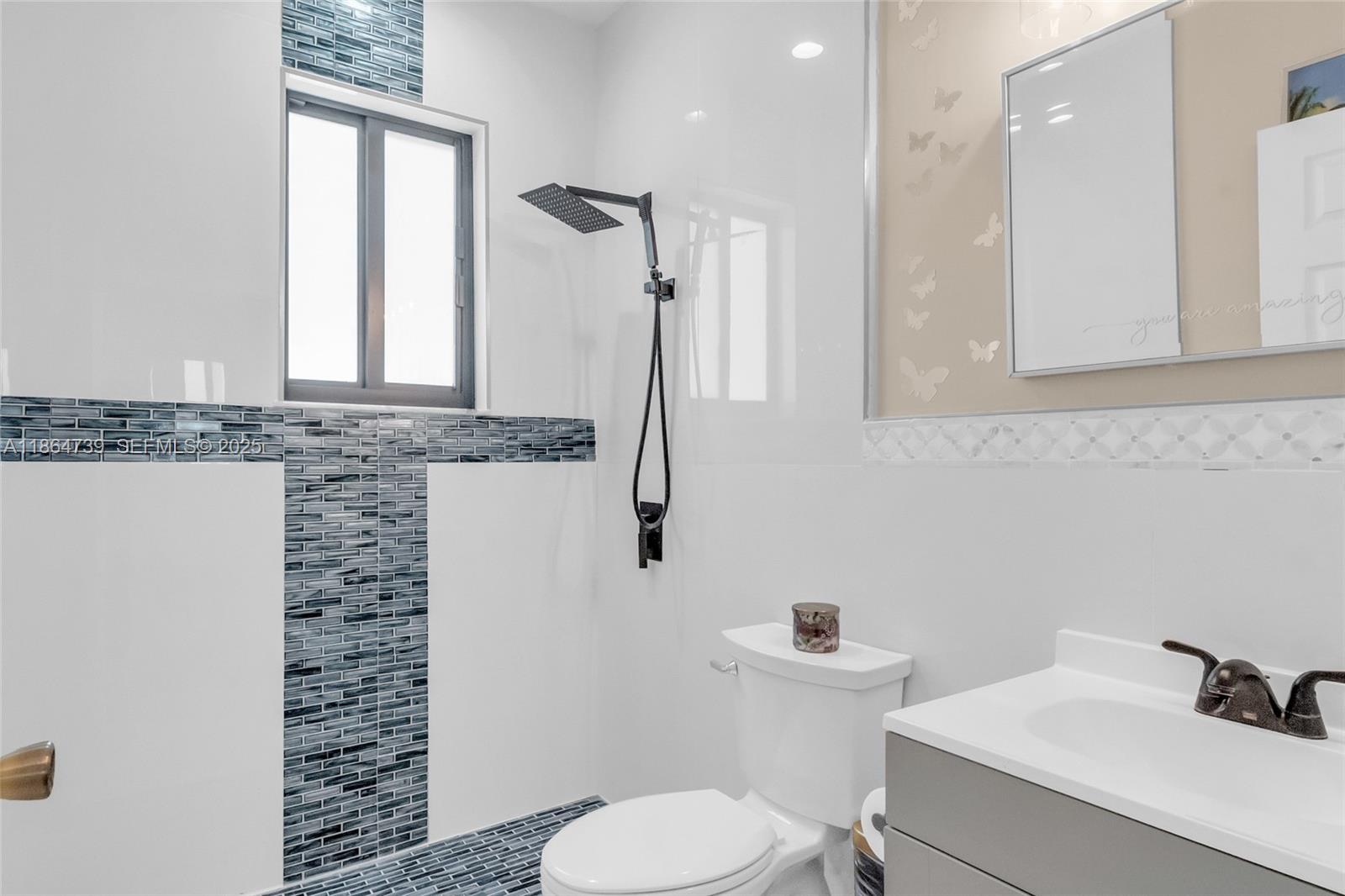 1635 Southeast 20th Terrace Homestead, FL 33035 - Photo 46 of 52 a bathroom with a sink a toilet and a mirror